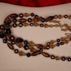 Elegant beaded necklace with brown and gold accents.