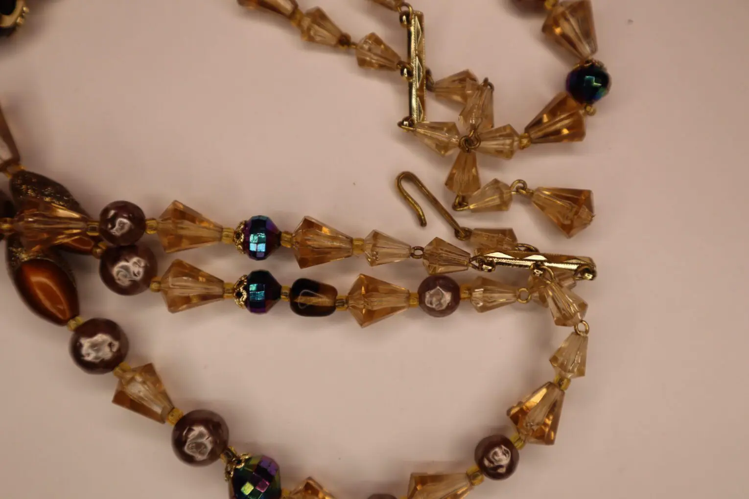 Beaded necklace featuring warm amber and brown tones.