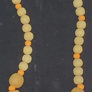 Beaded necklace with orange and wooden accents.