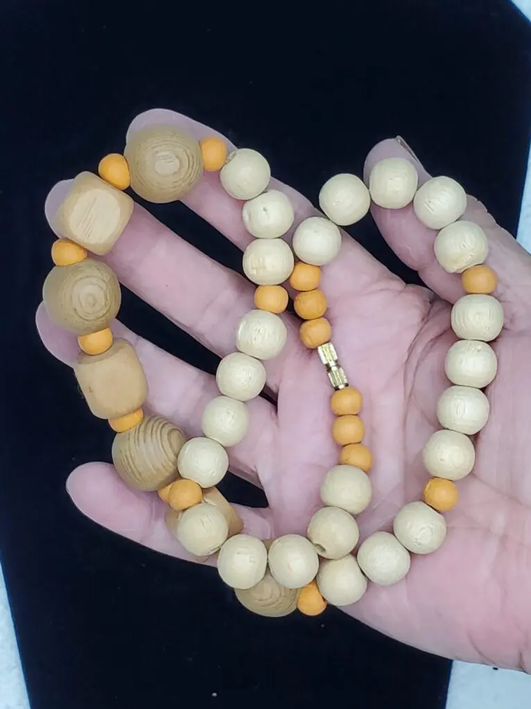 Natural wooden bead necklace with orange accents.