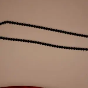 Black beaded necklace with geometric design.
