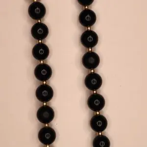 Black beaded necklace with decorative silver accents.