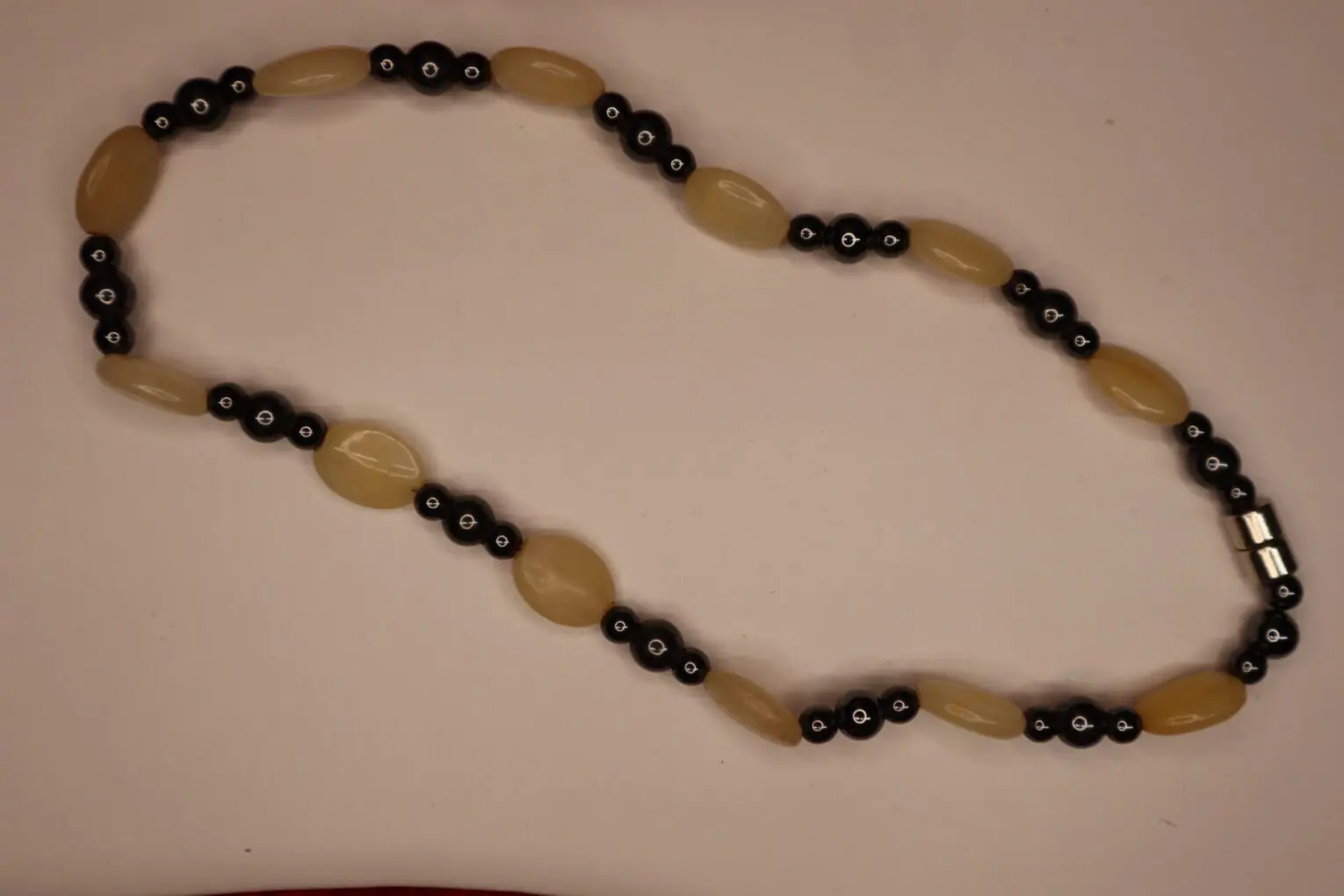 Beaded necklace with yellow and black accents.