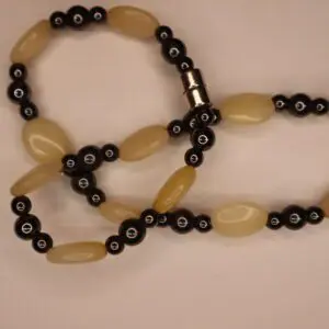 Unique beaded bracelet with black and cream colors.