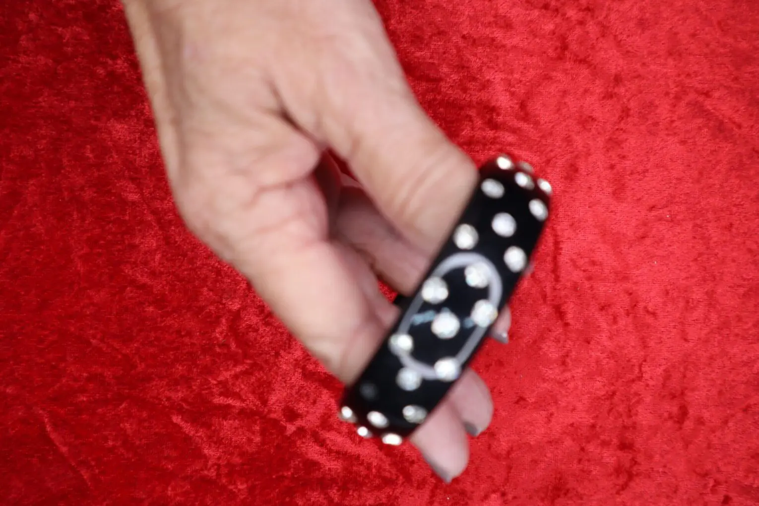 Black bracelet adorned with silver studs.
