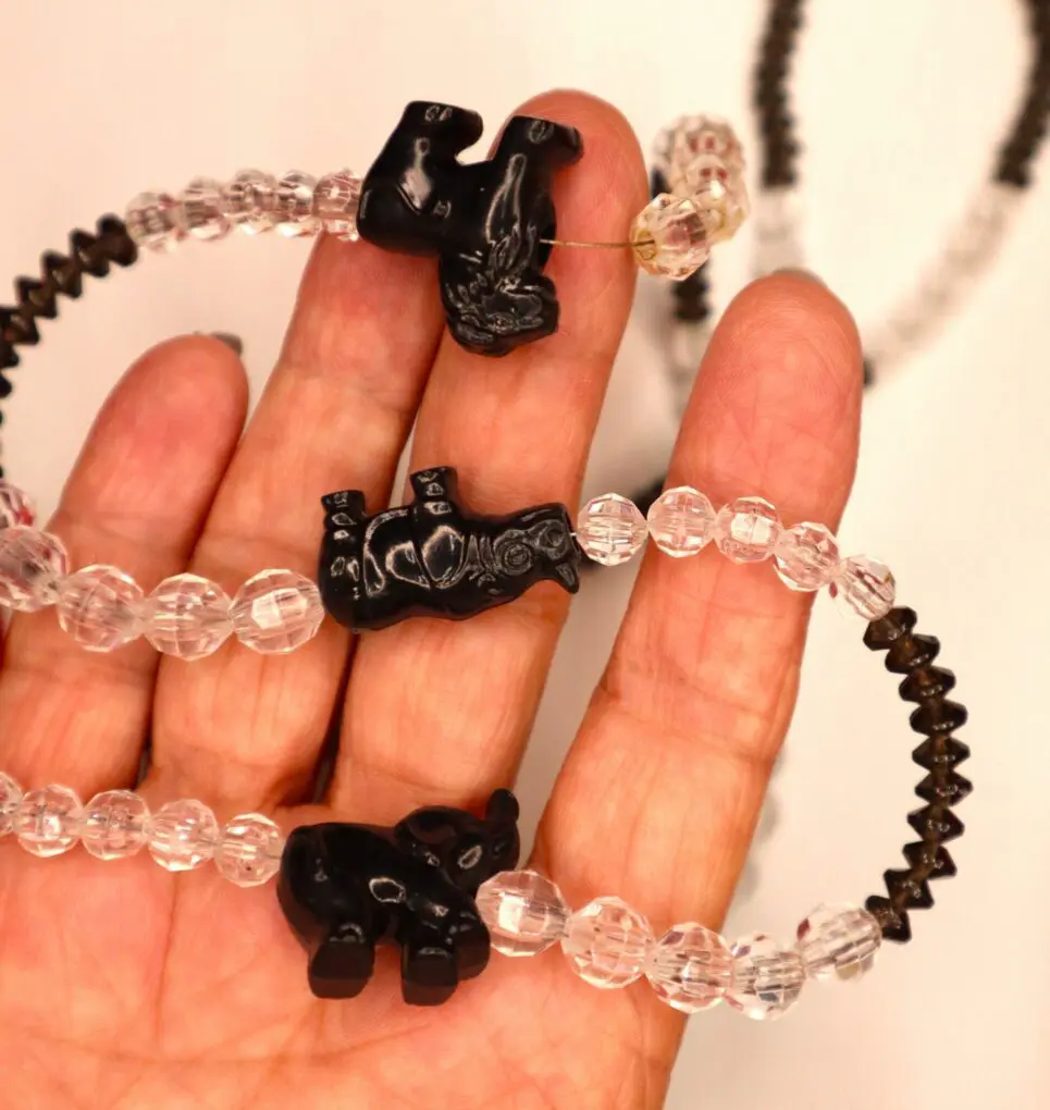 Beaded necklace featuring black animal charms.