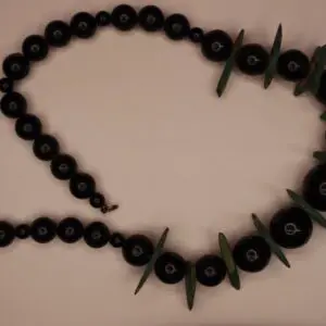 Black beaded necklace with green accent pieces.