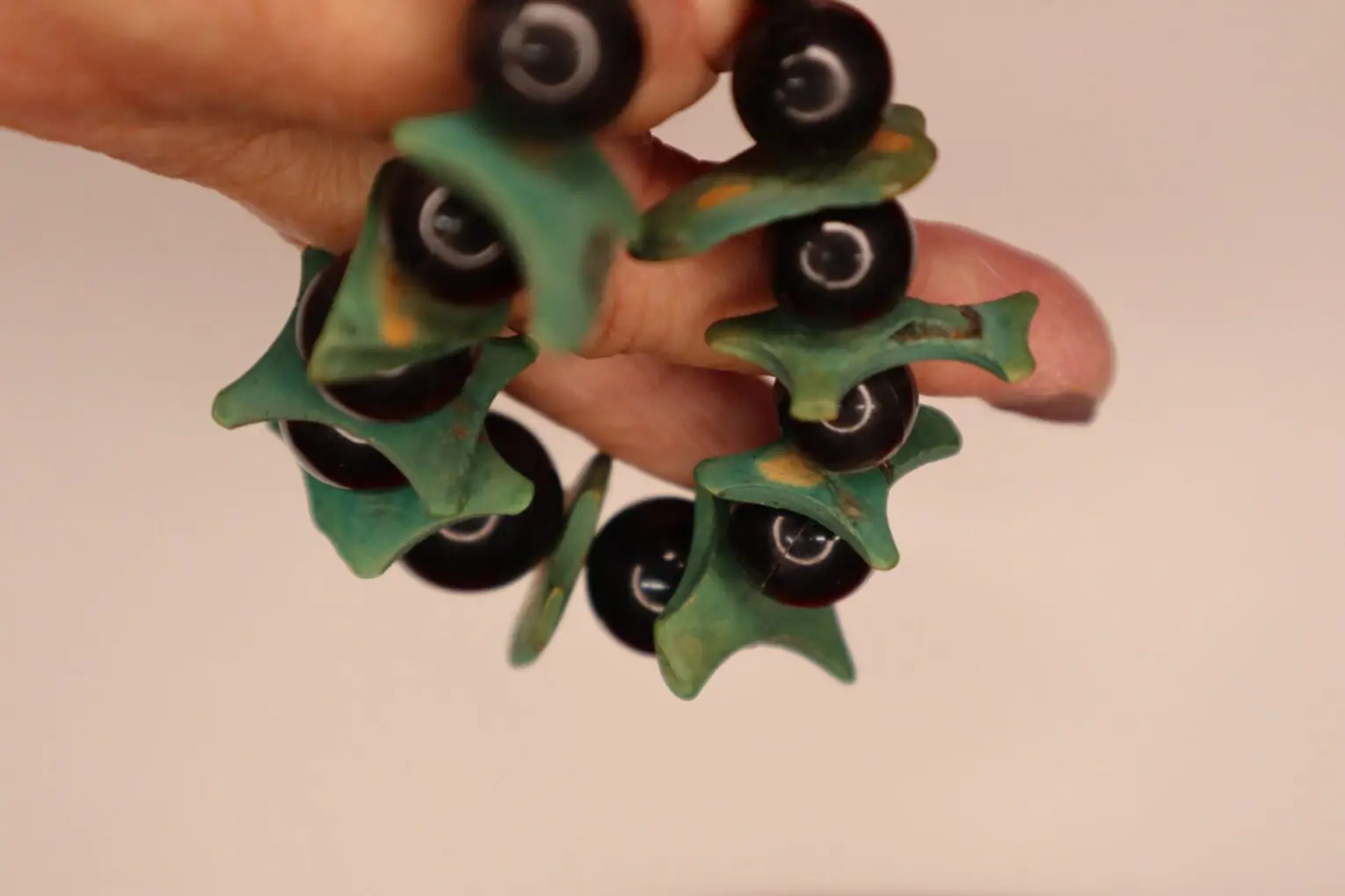 Colorful bracelet with green and black elements.