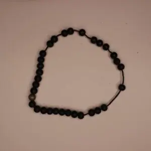 Black beaded necklace with a decorative accent.