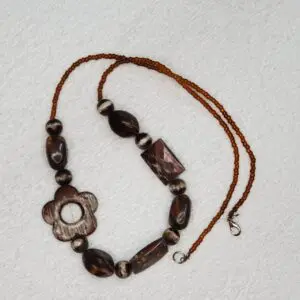 Beaded necklace with floral and geometric shapes.