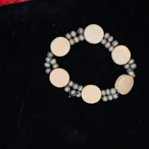 Beaded bracelet with circular wooden and silver elements.