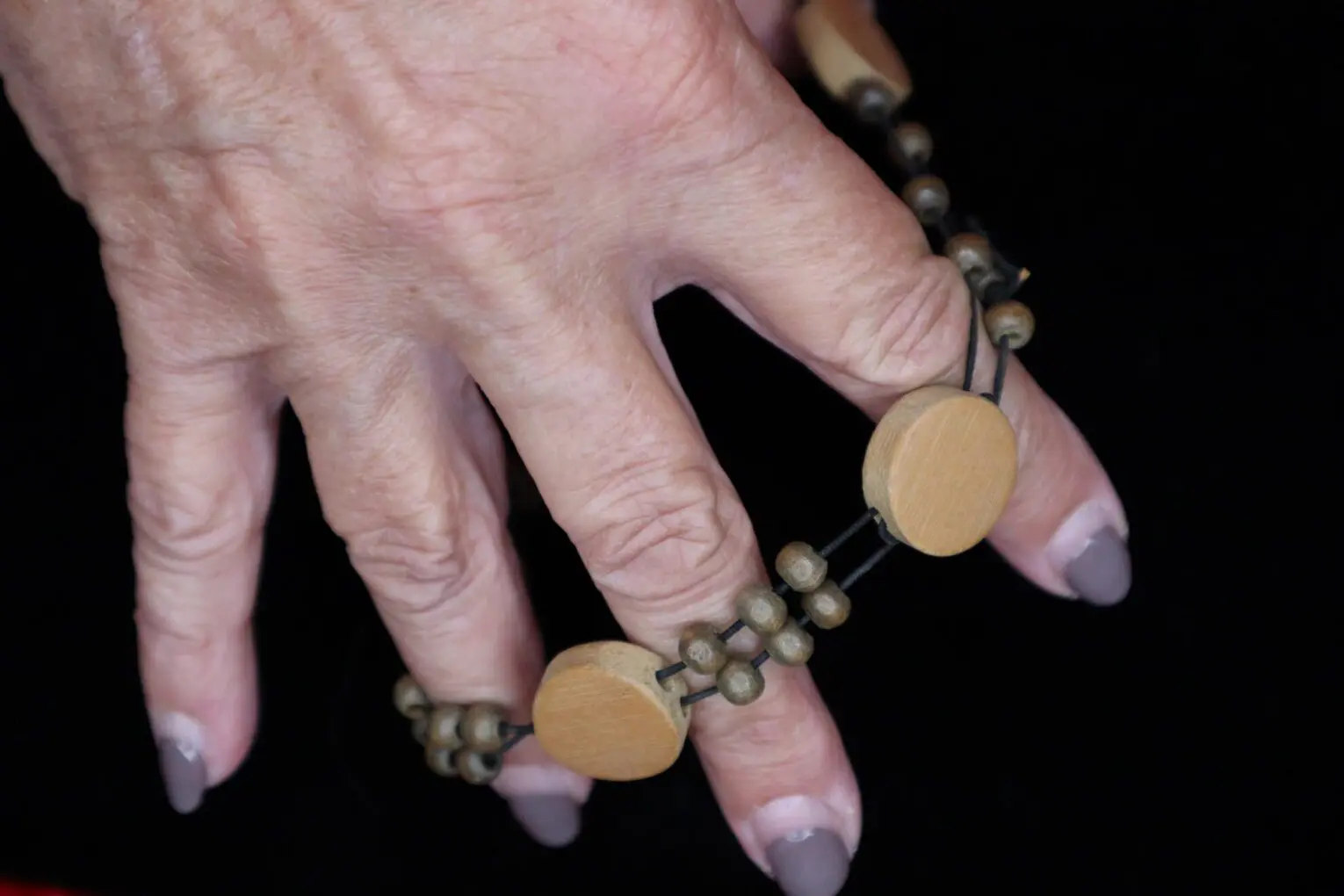 Wooden bead necklace with circular accents displayed.