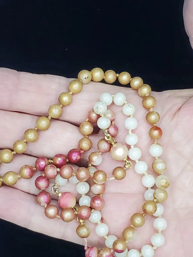 Colorful beaded necklace with gold and pink accents.