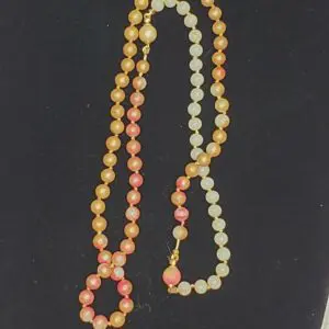 Colorful beaded necklace with orange and pink hues.