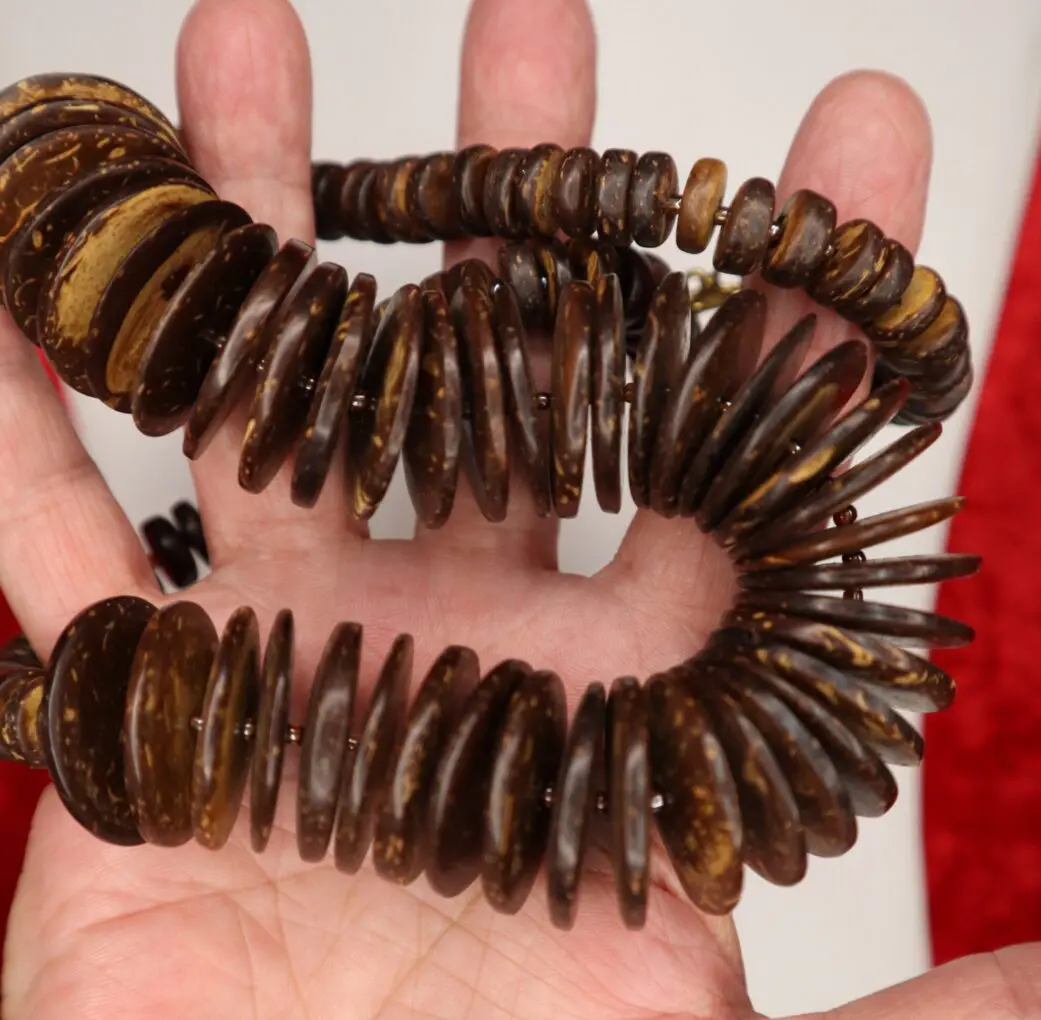 Brown beaded necklace with circular disc shapes.