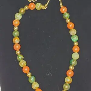 Colorful beaded necklace with orange and green.