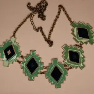 Geometric necklace with green and black elements.