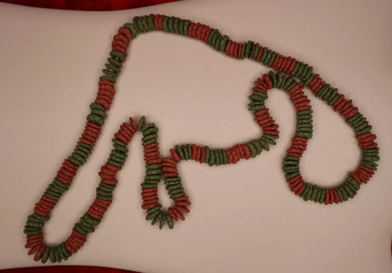 Colorful necklace featuring red and green beads.