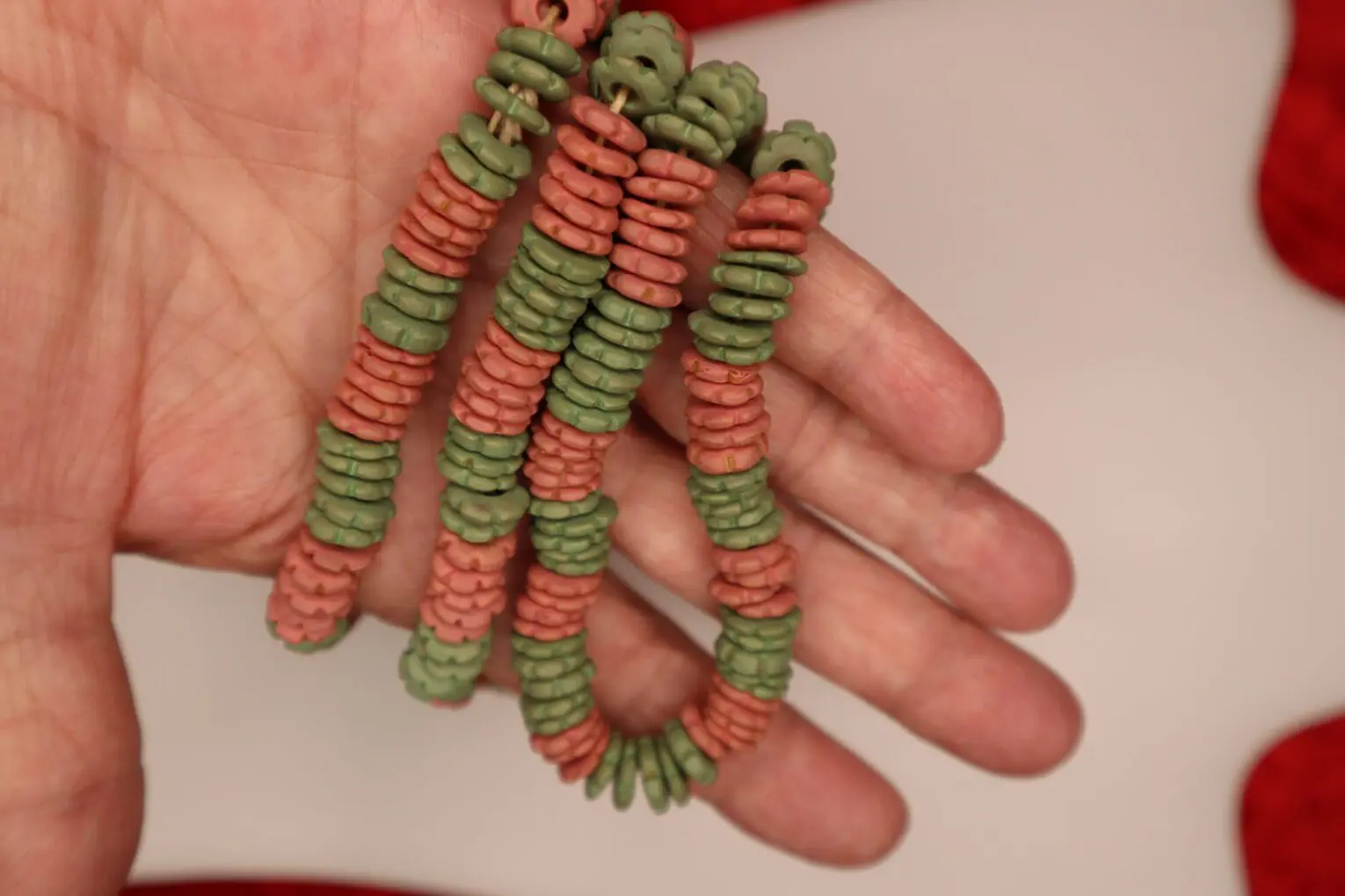 Colorful beaded bracelet with green and pink hues.