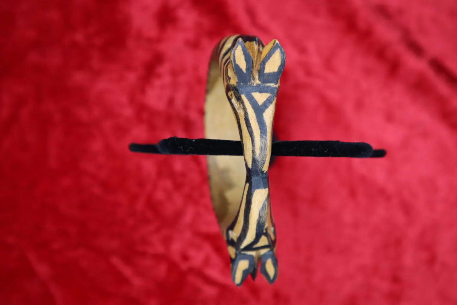 Decorative wooden bracelet with animal design.