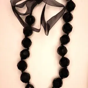 Black beaded necklace with ribbon bow detail.
