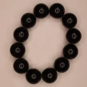 Black beaded bracelet with circular designs displayed.