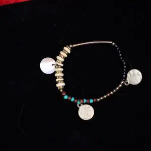 Beaded bracelet with unique circular charm details.