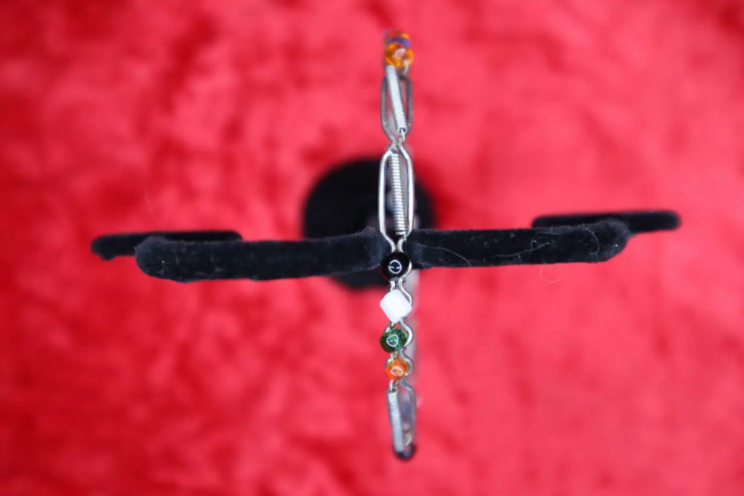 Silver bracelet with colorful bead accents displayed.