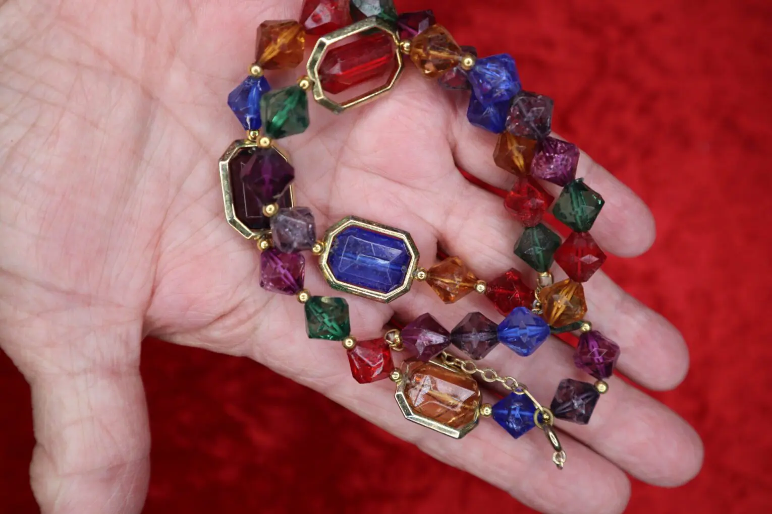 Colorful beaded bracelet with geometric shapes displayed.
