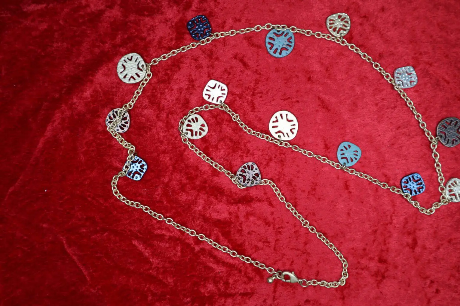 Colorful chain necklace with patterned metal discs.