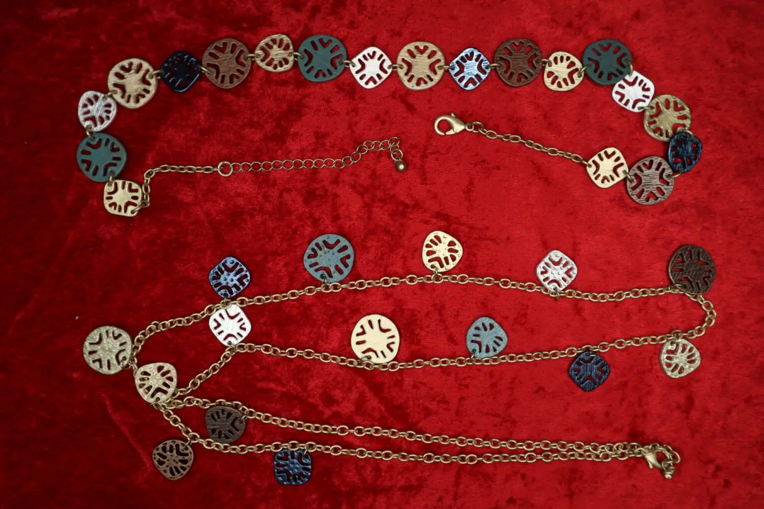 Colorful layered necklace with unique circular charms.