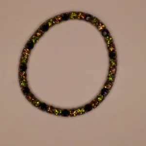 Colorful bracelet featuring green and amber stones.