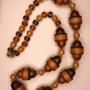 Wooden bead necklace with intricate design elements.