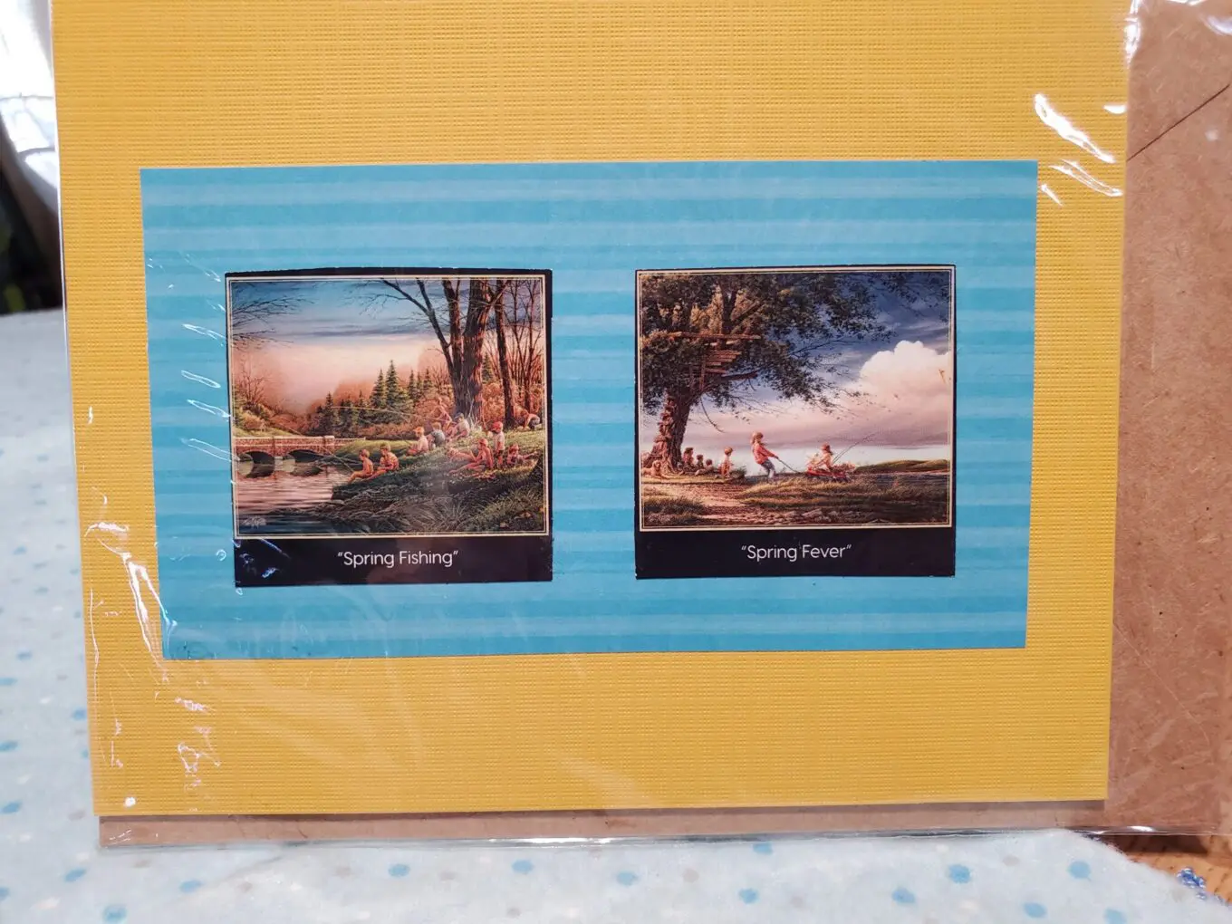 Framed spring-themed artwork with fishing scenes.
