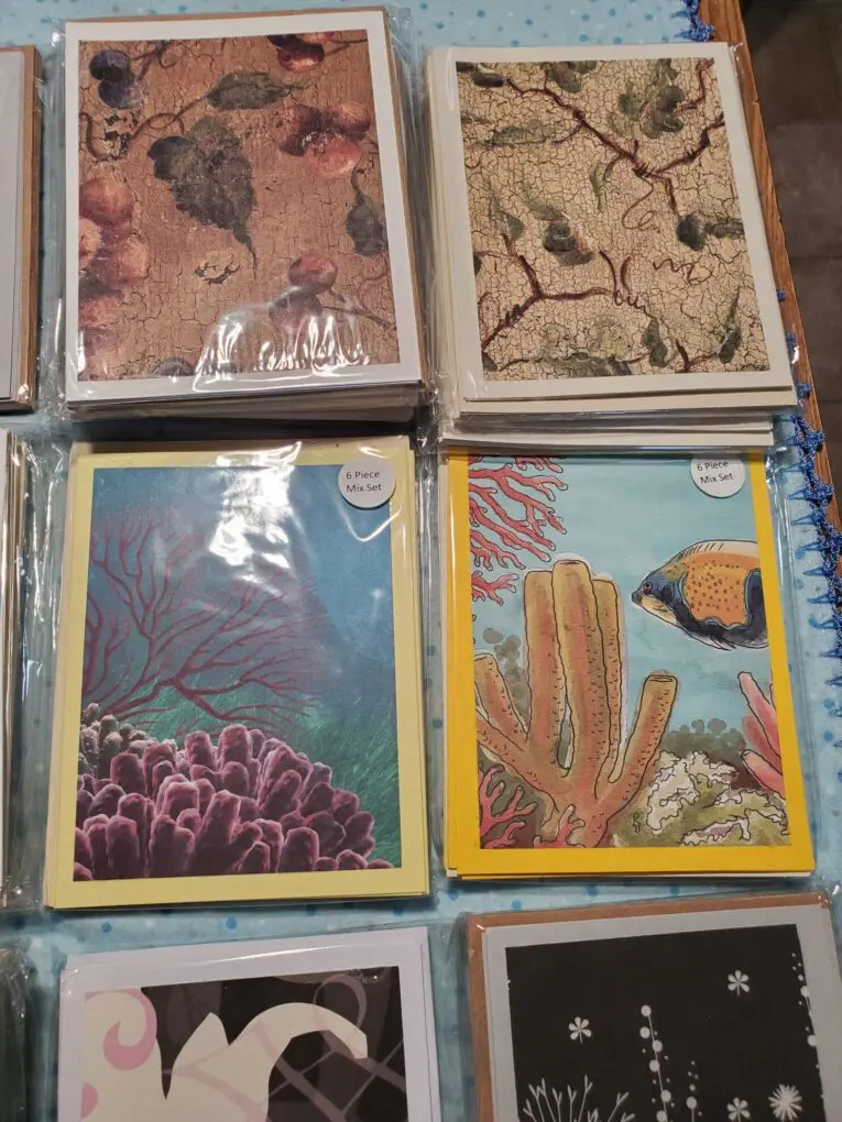 Assorted greeting cards with vibrant coral designs.