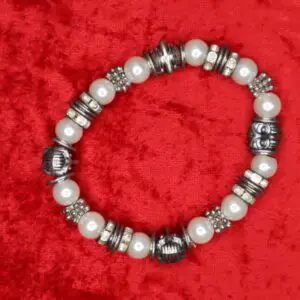 Silver and pearl bracelet with decorative accents.