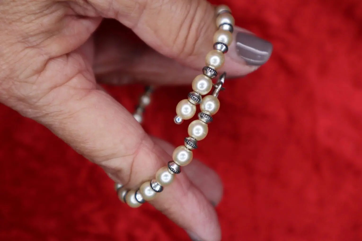 Elegant pearl bracelet with silver accents displayed.