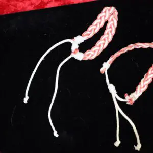 Braided bracelets in pink and white colors.