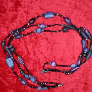 Colorful beaded necklace with purple and black accents.