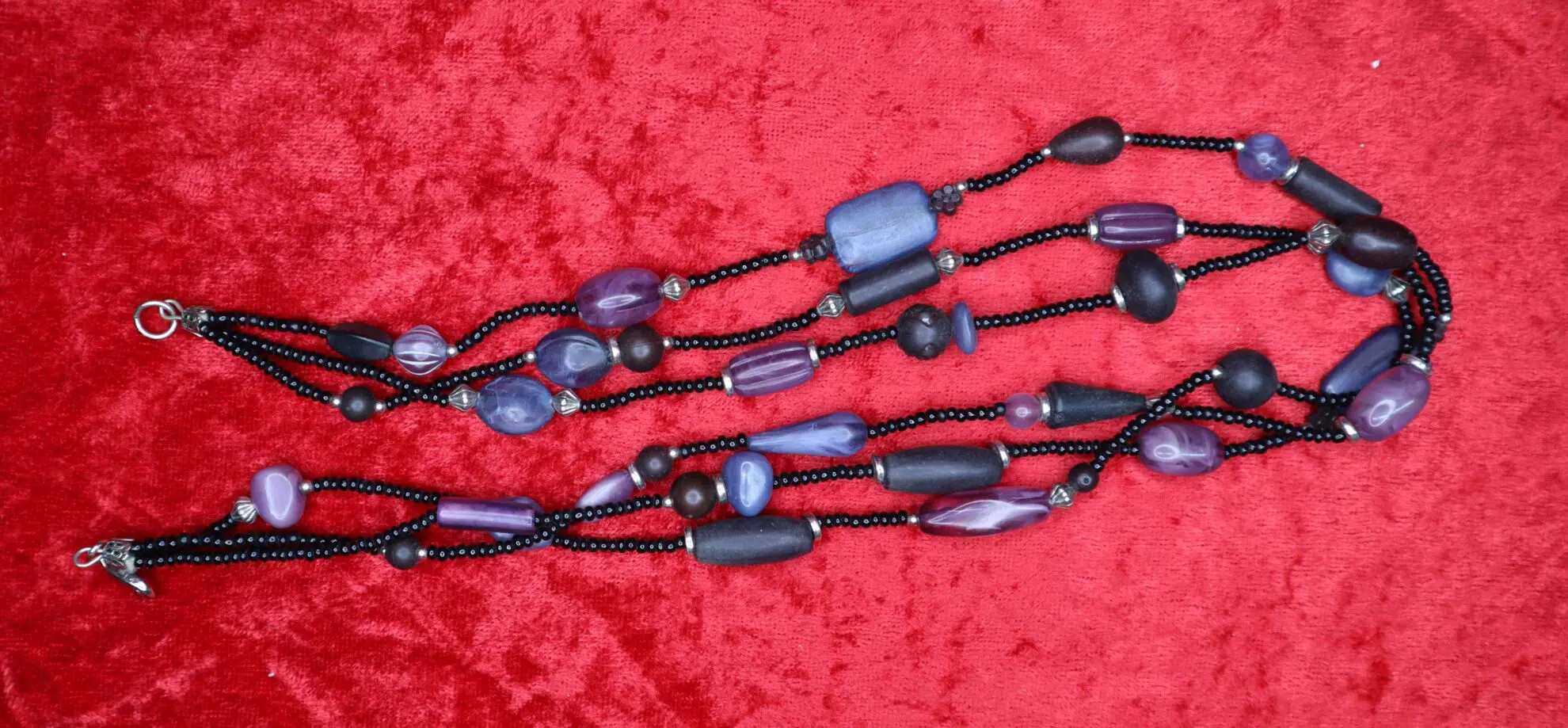 Colorful beaded necklace with purple and black.