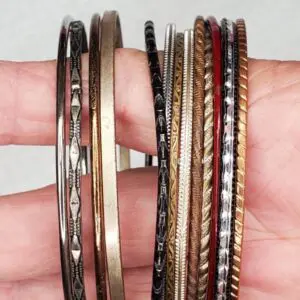 Assorted bangles in various metallic finishes.