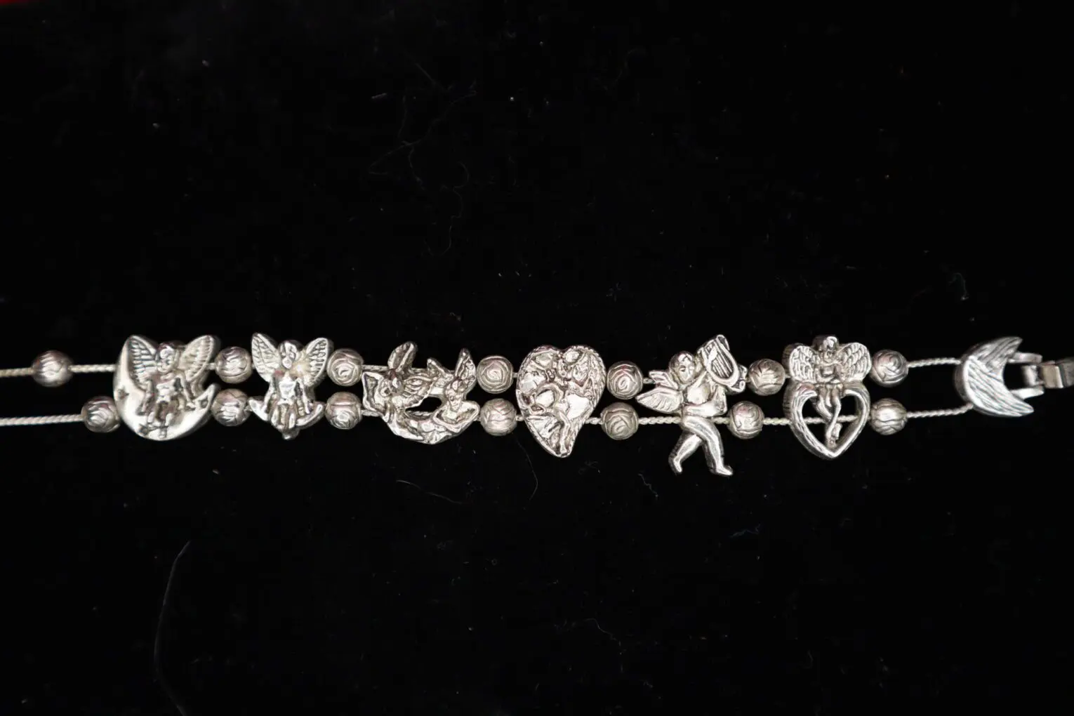 Silver bracelet adorned with whimsical charm designs.