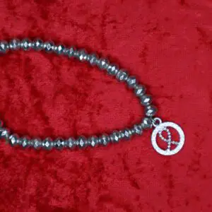 Beaded necklace featuring a peace symbol charm.