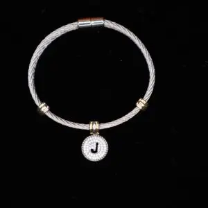 Silver cable bracelet with decorative letter charm.