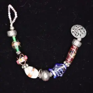 Colorful beaded bracelet with unique charm designs.
