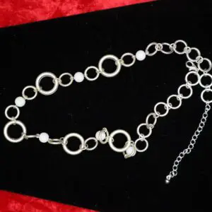 Silver necklace with circular links and beads.