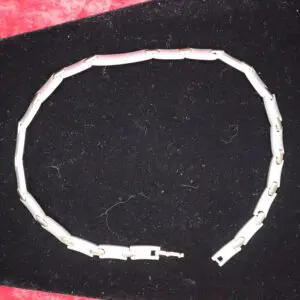 Sleek silver bracelet with elongated link design.