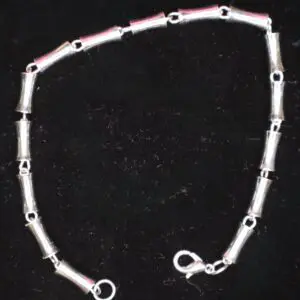Silver bracelet with cylindrical link design.
