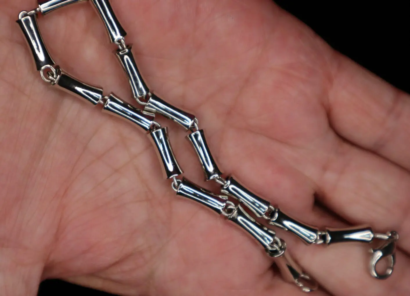 Silver bracelet with bamboo-style links displayed.