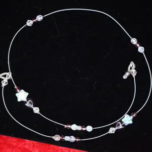 Delicate beaded necklace with star and heart charms.